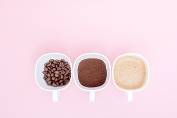 Three cups of difference stages of coffee preparation or the making of coffee drink isolated on pink background, copy space. Top view