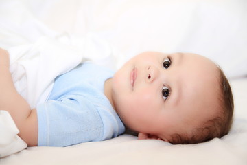 little baby boy in bed at home