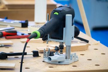 Milling machine for wood. Vertical router on the workbench. Milling manufacture of wooden parts. Woodworking. Furniture manufacturing.