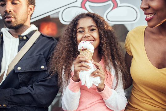 Portrait of girl eating ice cream outdoors 
