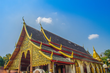 Naklejka premium Beautiful golden buddhist church in Lanna-style ordination hall enshrines at Wat Chiang Man or Wat Chiang Mun, the oldest temple in Chiang Mai, Thailand, built in 1296 by King Mengrai in Lanna-style.