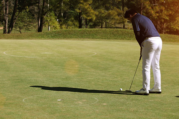 Fototapeta premium Blurred golfers are putting golf in the evening golf course in Thailand
