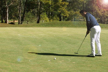 Golfers are playing golf in the evening golf course