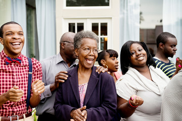 Smiling multigenerational family standing outdoors