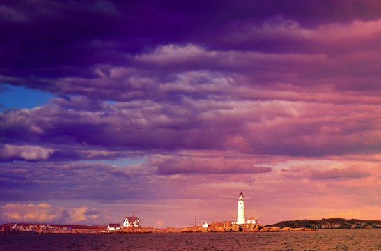 Lighthouse Outside Of Boston Harbor With Purple Clouds