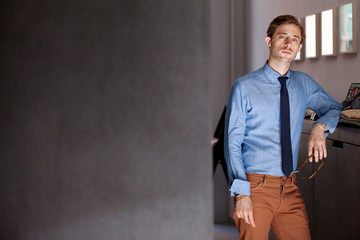 Stylish man standing in apartment 