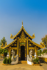 Fototapeta premium Beautiful golden Buddhist church in Lanna style architecture at Wat Inthakin Sadue Muang, Chiang Mai, Thailand. Wat Inthakin is the Buddhist temple where the Chiang Mai city pillar was placed in 1296.