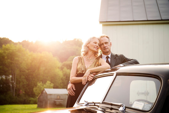 Elegant Mature Couple Standing By Retro Style Car 