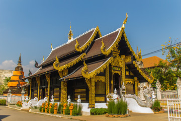 Beautiful golden Buddhist church in Lanna style architecture at Wat Inthakin Sadue Muang, Chiang Mai, Thailand. Wat Inthakin is the Buddhist temple where the Chiang Mai city pillar was placed in 1296.