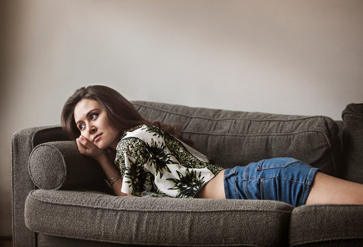 Young woman relaxing on sofa 