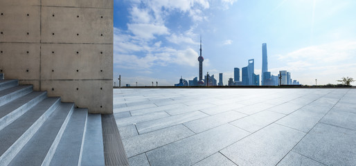 Empty square floor and backlit city skyline in Shanghai,China