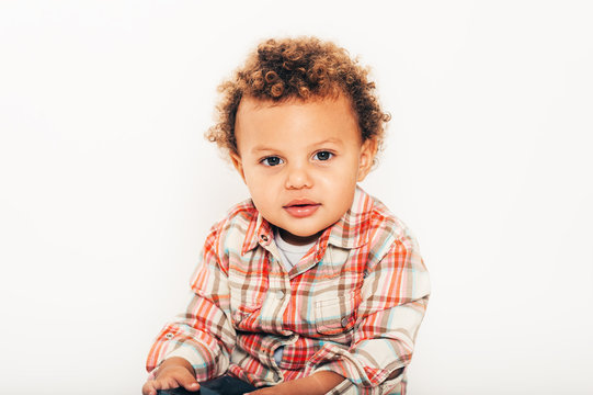 Studio Shot Of Handsome African Toddler Boy Wearing Orange Plaid Shirt, Posing On White Background