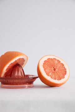 Cross section of grapefruit and juice squeezer 