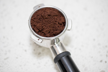 Barista presses ground coffee using tamper. color picture - Image