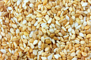 Enlarged sesame seeds forming background filled with their seeds.