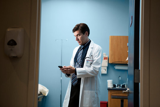 Doctor texting on mobile phone 