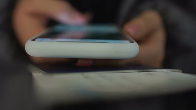 Girl holding passport and registering for visa application online, closeup