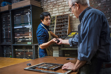 Men working in print workshop 