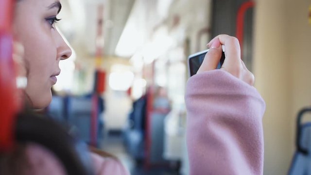 Girl filming city with phone while traveling by bus, live streaming, travel blog