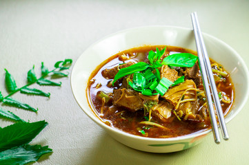 Noodles with pork stewed on a cream table