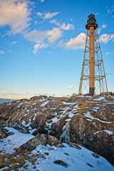 View of a lighthouse in massachusetts during a clear day in the winter