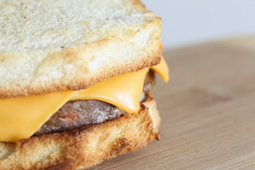 Close-up of a Vegetarian Homemade Sanswich on a Wooden Board. White Background.