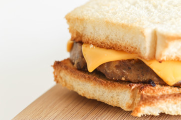 Close-up of a Vegetarian Homemade Sanswich on a Wooden Board. White Background.