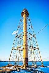 View of a lighthouse in massachusetts during a clear day in the winter