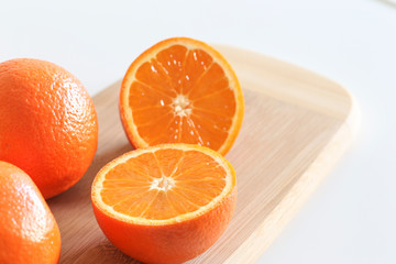 Fresh Oranges on a Wooden board. White background.