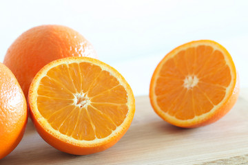 Fresh Oranges on a Wooden board. White background.