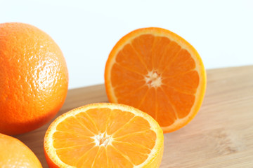 Fresh Oranges on a Wooden board. White background.