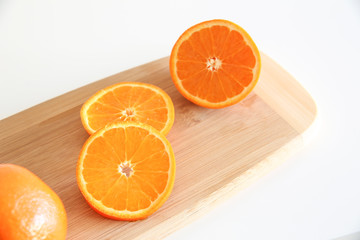 Obraz na płótnie Canvas Fresh Oranges on a Wooden board. White background.