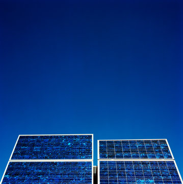 Solar panels against blue sky 