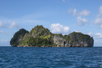 Naklejka premium Rock Island with Arch Rises from Pacific in Micronesia