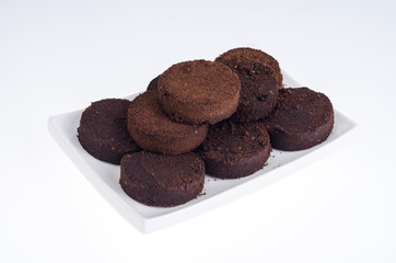 Pressed waste coffee beans on white background