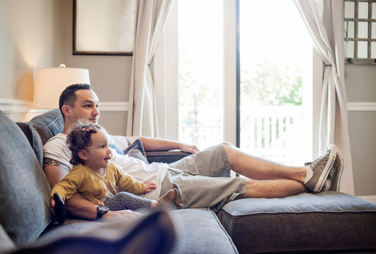 Baby girl (12-17 months) watching TV with father 