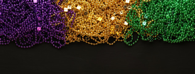 Purple, Gold, and Green Mardi Gras beads background © Leigh Prather