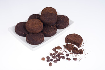Pressed waste coffee beans on white background