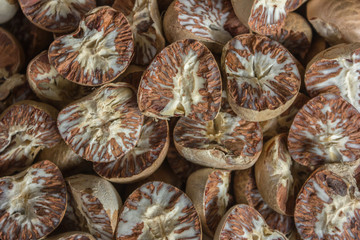 Dry betel nuts stacked together macro shot . half cut areca nuts. 