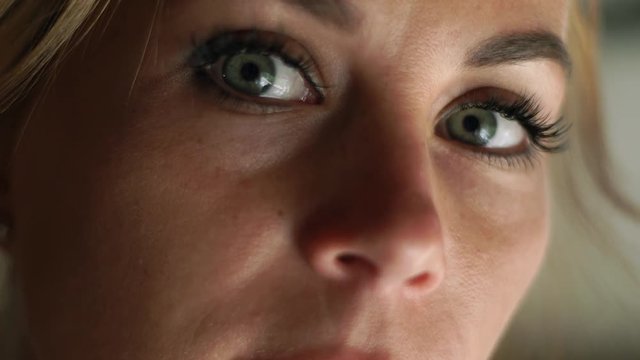 Close up face woman looking to camera. Portrait sad woman. Female face, eyes, eyelashes and eyesbrows. Natural beauty and makeup.