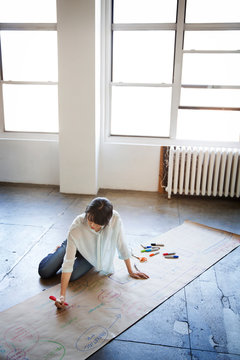 Young woman brainstorming and writing ideas 