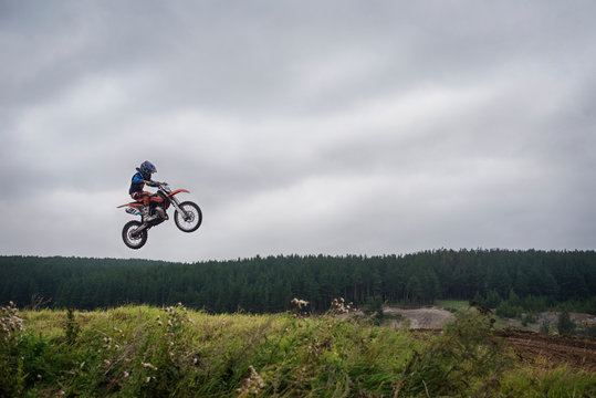 Motocross rider (12-13) in mid air 