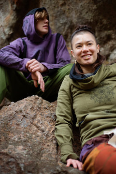 Young people sitting on rocks  