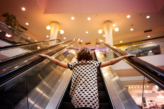 Girl going up on escalator 