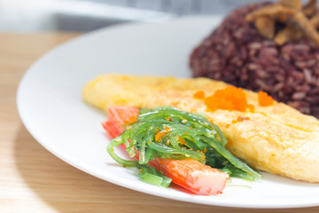Rice with omelette on plate