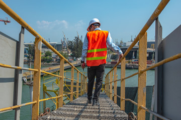 walkway gangway bridge laying from side to side, walking in mind step on the steel gangway bridge at workplace, working in high stage & level of insurance