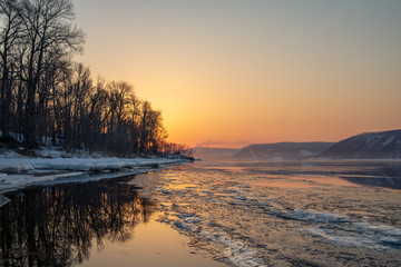 Melting ice on the river. Spring. Sunset in the Zhiguli mountains.