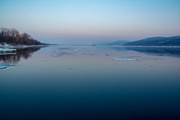 Fototapeta premium ice floats on the river at sunset
