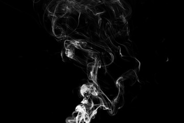 Smoke the white incense on a black background. darkness concept