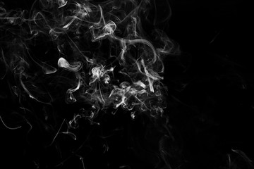 Smoke the white incense on a black background. darkness concept
